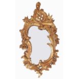 An Italian giltwood mirror, 19th c, in rococo style, crested by trellis flanked by flowers and