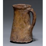 A Medieval English pottery drinking jug, 11th-12th c, of fine light sandy fabric, tapered form