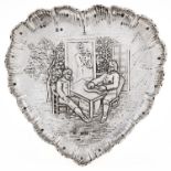 A Continental heart shaped silver dish, embossed with a seated musician and two other figures at a