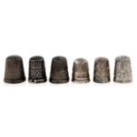 Six Victorian and later silver thimbles, including an unusually pieerced floral example, Chester