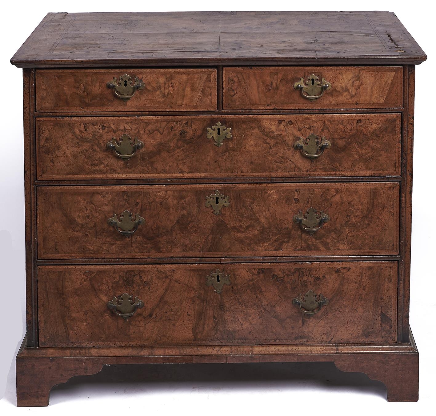 A George II walnut and feather banded chest of drawers, the quarter veneered, moulded top above