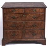 A George II walnut and feather banded chest of drawers, the quarter veneered, moulded top above