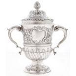 A George II silver cup and a cover,  wrythen fluted and chased with roses at later date., 26cm h,