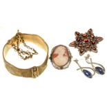 A garnet set silver star brooch, Nepal, late 20th c, a pair of sodalite earrings in silver, a