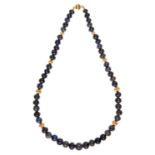 A necklace of purple pyrite beads with gold spacers, 43cm, marked on clasp 14k Good condition