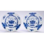 Two Dutch Delftware plates, 18th c, painted in Kangxi style in blue with a basket of flowers and
