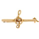 A diamond bar brooch, in the form of a treble clef, in gold, 2.7g Good condition, engraved