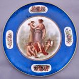 A Continental porcelain blue ground dish, c1900, painted with mythological figures and border sprays