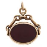 A 9ct gold watch fob swivel shield, onyx and cornelian set, 9.8g Good condition