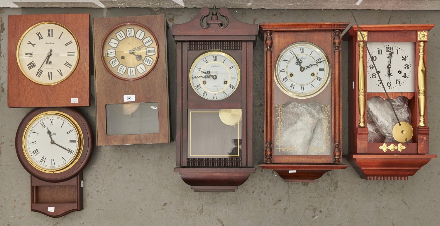 Six modern wall clocks, various sizes