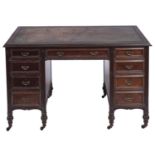 A Victorian mahogany desk, c1890, with tooled leather inset rectangular top, fitted nine moulded