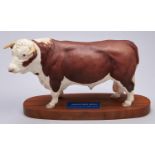 A Beswick model of a Hereford Bull, 1976-1989, wood base, 18.5cm h Good condition