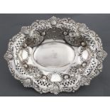 A Victorian pierced and die stamped silver fruit bowl, with slightly domed centre and border of