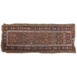 An antique red ground rug - 103 x 265cm Wear and losses at ends