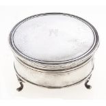 A George V round silver trinket box, on three feet, the lid initialled N, 11cm diam, by Walker &