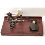 A watchmaker?s lathe, on mahogany base Apparently complete but for chuck. Note: sold without motor