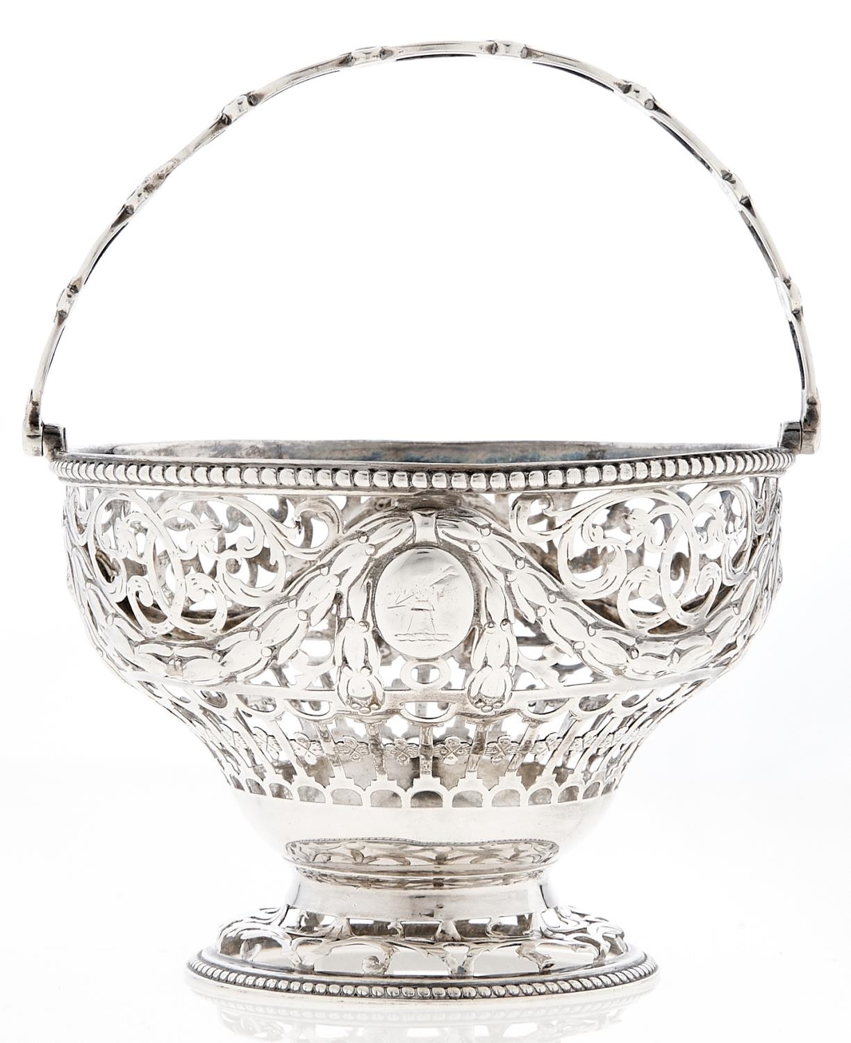 A George III neo classical sugar basket, chased and pierced with husks and festoons between beaded