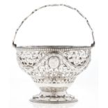 A George III neo classical sugar basket, chased and pierced with husks and festoons between beaded