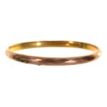 A gold bangle, early 20th c, 90mm, marked 9ct, 11g Split in one place
