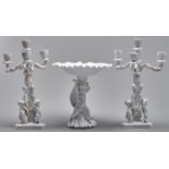 A pair of Copeland glazed porcelain cherub candelabra and a similar fruit stand, early 20th c,