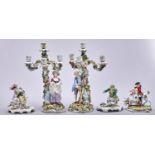 A pair of Plaue on Havel floral encrusted candelabra, late 19th c, with the figures of a boy or