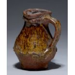 A Medieval English pottery biconic jug, 13th / 14th c, of fine pinkish buff sandy fabric with
