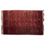 A red ground Bokhara rug - 120 x 196cm Light wear and localised soiling