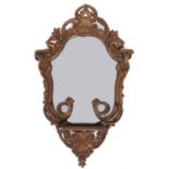 A rococo style giltwood and composition mirror, late 19th c, 80cm h; 49cm l, printed trade label