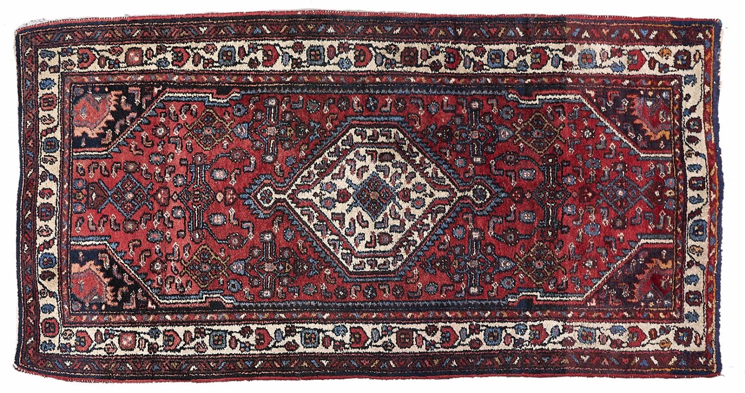 A Caucasian style red ground rug, 87 x 192cm Good condition but for requiring a clean