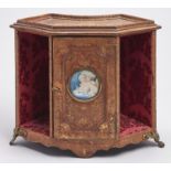 A French gilt tooled leather miniature table top bookcase, early 20th c, the door to the central