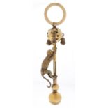 An unusual Victorian articulated silver gilt climbing monkey novelty baby's rattle, with three