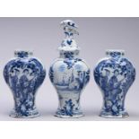 A Dutch Delftware garniture, 18th c, the three vases painted with a Chinese musician playing a lute,