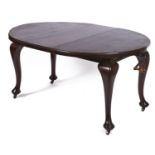 A mahogany dining table, early 20th c, with semi-circular ends, on cabriole legs and castors, with a