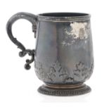 A George V silver christening mug, with pseudo cut card ornament, 95mm h, by Wakely & Wheeler,