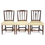 A set of three George III mahogany dining chairs, the channelled back with straight top rail and
