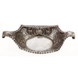 A Victorian pierced and die stamped silver sweetmeat dish, with scroll handles and crimped rim,