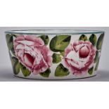 A Wemyss ware dog bowl, c1900, painted possibly by Joe Nekola, with roses, 16.5cm diam, impressed