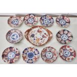 Twelve similar Japanese Imari dishes, Meiji period, 21.5cm diam and circa and a Kutani cabaret