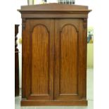 A Victorian mahogany wardrobe, c1860, the cornice with architectural pediment above a pair of arched