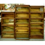 A set of three Amyl sectional bookcases, the interiors bearing brass Amyl labels with registered