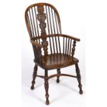 A Victorian yew wood high back Windsor chair, East Midlands region, with crinoline stretcher and elm