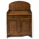 A Cotswold School oak washstand, c1930, with two drawers above panelled doors, 113cm h; 55 x 79cm