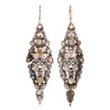 A pair of diamond earrings, 19th c, mounted in silver and gold, articulated, 64mm excluding wire