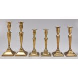 Three pairs of English brass candlesticks, two early 19th c, the largest pair later, one with