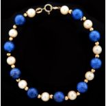 A lapis lazuli and cultured pearl bracelet, with gold spacers and clasp marked 14k Good condition