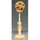 A Chinese carved ivory puzzle ball, the stand in the form of Shou Lao, 19th c, 23cm h Dust stained