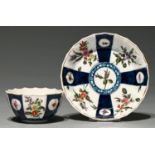 A Worcester fluted  tea bowl and saucer, c1770, Queen's pattern and enamelled with loose bouquets
