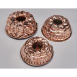 Kitchenalia. Three similar copper culinary moulds, 19th / 20th c, with rolled rim, tinned, 25-28cm