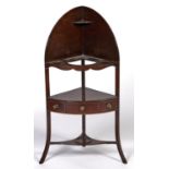 A George III mahogany corner washstand, c1800, with arched shelved back above bowed tier for bowls
