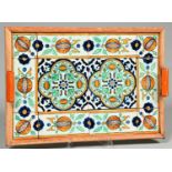 A tiled wood tray, early 20th c, the pair of 13cm polychrome tiles in a surround of ten flower and